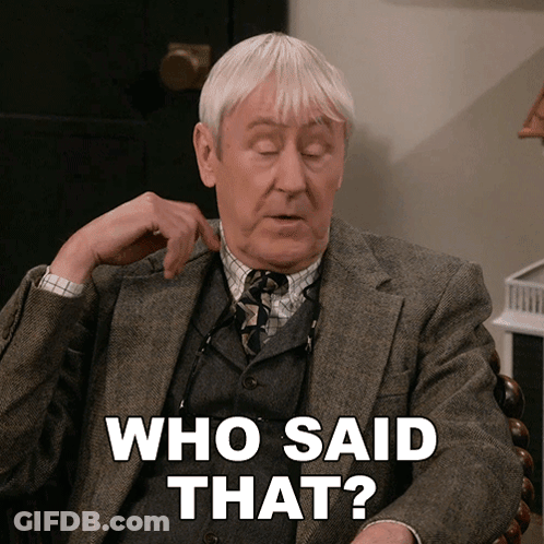 A Man In A Suit And Tie Is Sitting In A Chair And Says " Who Said That " GIF