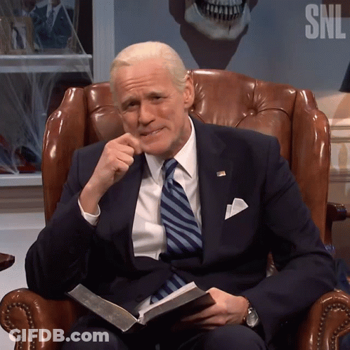 Man In Suit And Tie Sitting With SNL Logo GIF