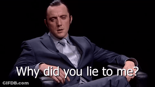 A Man In A Suit And Tie Is Sitting In A Chair With His Eyes Closed And The Words Why Did You Lie To Me Above Him GIF
