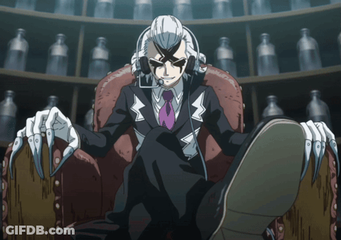 A Man In A Suit And Tie Is Sitting In A Chair With His Feet Crossed GIF