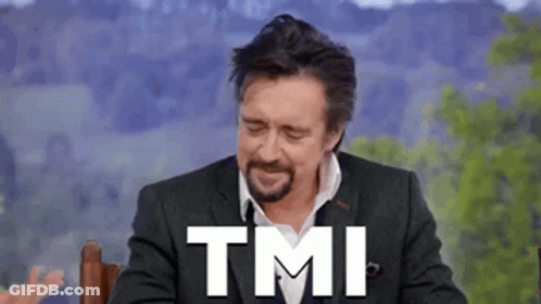 A Man In A Suit And Tie Is Sitting In A Chair With The Words Tmi Written On His Face . GIF