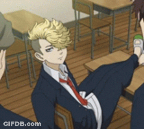 A Man In A Suit And Tie Is Sitting In A Classroom With Other Students . GIF