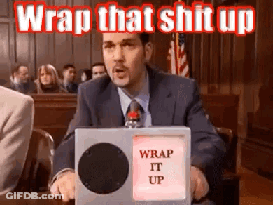 A Man In A Suit And Tie Is Sitting In A Courtroom Holding A Box That Says `` Wrap That Shit Up '' . GIF