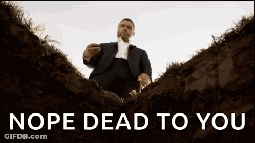 A Man In A Suit And Tie Is Sitting In A Grave With The Words Nope Dead To You Above Him . GIF