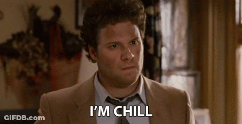 A Man In A Suit And Tie Is Sitting In A Room And Saying I 'M Chill . GIF