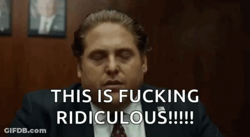 A Man In A Suit And Tie Is Sitting In A Room With His Eyes Closed And Saying This Is Fucking Ridiculous . GIF