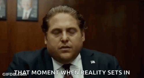 A Man In A Suit And Tie Is Sitting In A Room With His Eyes Closed And Says That Moment When Reality Sets In GIF