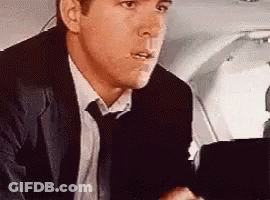 Man In Suit Sitting In Airplane Seat GIF