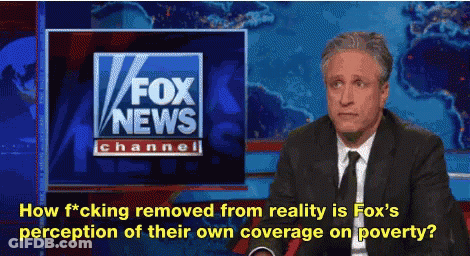 A Man In A Suit And Tie Is Sitting In Front Of A Fox News Channel Sign GIF