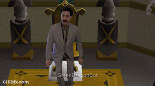 A Man In A Suit And Tie Is Sitting In Front Of A Green Dragonbot GIF