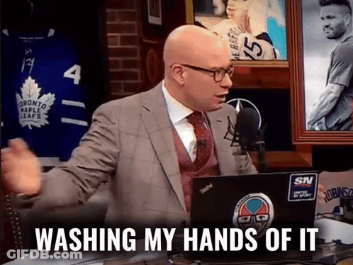 A Man In A Suit And Tie Is Sitting In Front Of A Laptop With The Words Washing My Hands Of It On It GIF