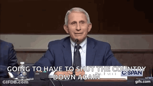 A Man In A Suit And Tie Is Sitting In Front Of A Microphone And Saying Going To Have To Shut The Country Down Again . GIF
