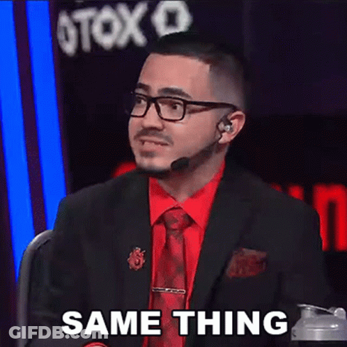 A Man In A Suit And Tie Is Sitting In Front Of A Microphone And Says Same Thing . GIF