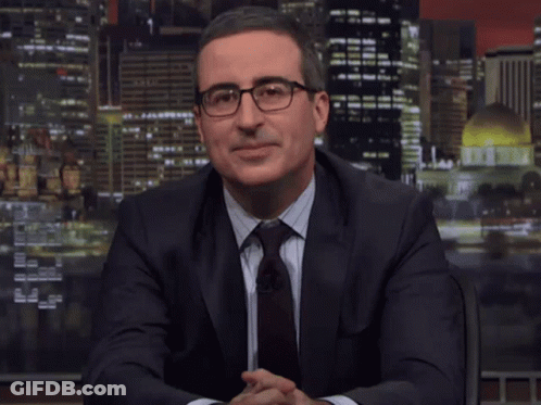 A Man In A Suit And Tie Is Sitting In Front Of A Screen That Says " Dope " GIF