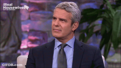 Man In Suit Sitting In Front Of Screen GIF