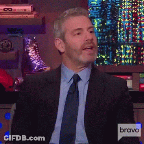 Man In Suit Sitting In Front Of Screen GIF