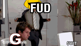 A Man In A Suit And Tie Is Sitting In Front Of A White Board With The Words Fud G And $ Wit GIF