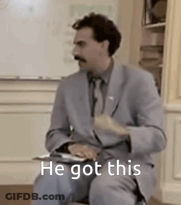 A Man In A Suit And Tie Is Sitting In Front Of A White Board With The Words `` He Got This '' . GIF