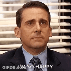A Man In A Suit And Tie Is Sitting In Front Of A Window With Blinds And Saying I 'M So Happy . GIF