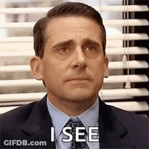 A Man In A Suit And Tie Is Sitting In Front Of A Window With Blinds And Says `` I See '' . GIF