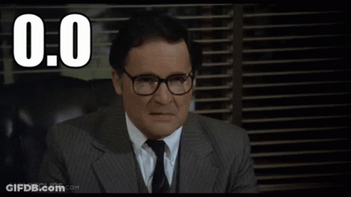 A Man In A Suit And Tie Is Sitting In Front Of A Window With The Number 0.0 Written Above Him GIF
