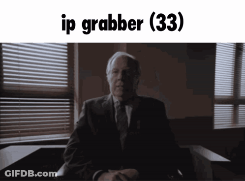 A Man In A Suit And Tie Is Sitting In Front Of A Window With The Words Ip Grabber ( 33 ) Written Above Him GIF