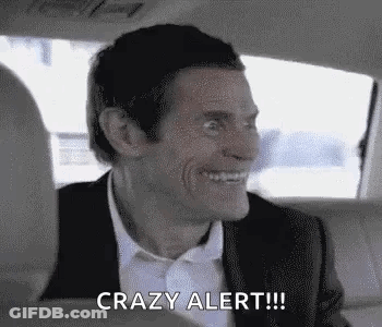 A Man In A Suit And Tie Is Sitting In The Back Seat Of A Car . GIF
