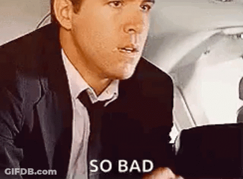 A Man In A Suit And Tie Is Sitting In The Back Seat Of A Plane . GIF