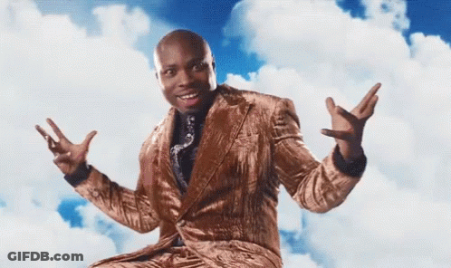 A Man In A Suit And Tie Is Sitting In The Clouds With His Arms Outstretched GIF