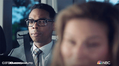 Man In Suit And Tie Next To Woman In Car NBC Logo GIF