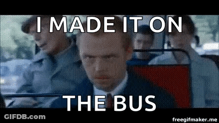 A Man In A Suit And Tie Is Sitting On A Bus And Making A Funny Face . GIF