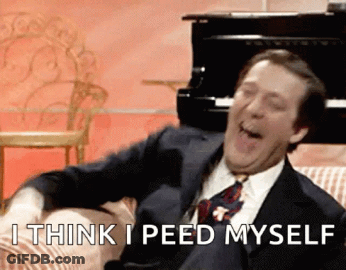 A Man In A Suit And Tie Is Sitting On A Couch And Says I Think I Peed Myself .. GIF