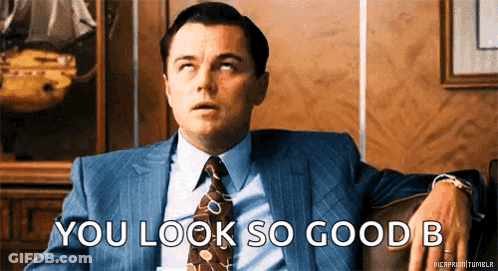 A Man In A Suit And Tie Is Sitting On A Couch Saying You Look So Good B GIF