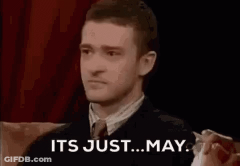 A Man In A Suit And Tie Is Sitting On A Couch With The Words `` It 'S Just ... May '' . GIF