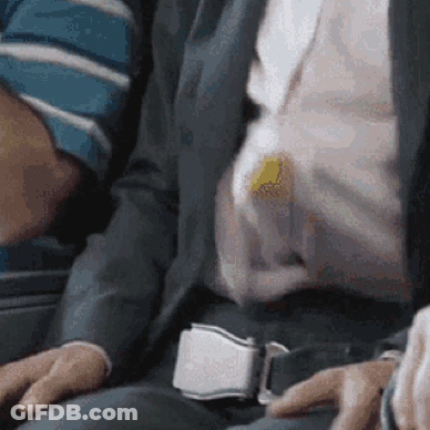 A Man In A Suit And Tie Is Sitting On A Plane GIF