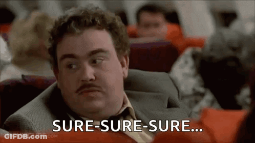 A Man In A Suit And Tie Is Sitting On An Airplane And Says Sure-Sure-Sure . GIF