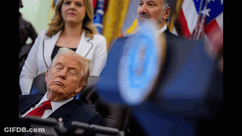 A Man In A Suit And Tie Is Sleeping In A Chair With His Eyes Closed GIF