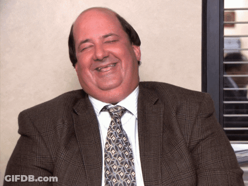 A Man In A Suit And Tie Is Smiling GIF