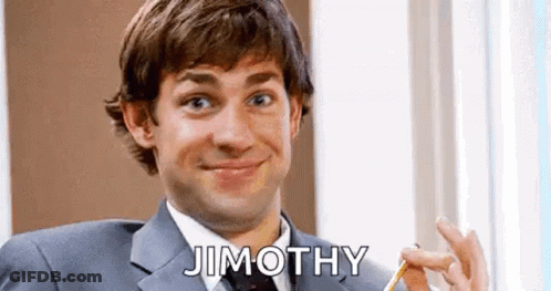 A Man In A Suit And Tie Is Smiling And Holding A Pencil In His Hand . GIF