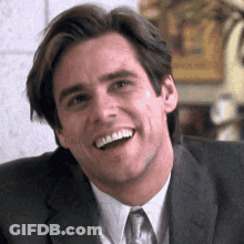 Smiling Man In Suit Looking At Camera GIF
