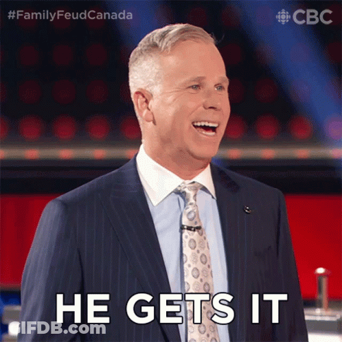 A Man In A Suit And Tie Is Smiling And Saying He Gets It GIF