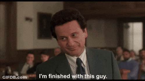 A Man In A Suit And Tie Is Smiling And Saying I 'M Finished With This Guy GIF