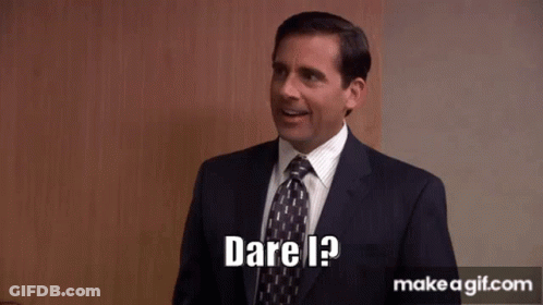 A Man In A Suit And Tie Is Smiling And Says Dare I ? GIF