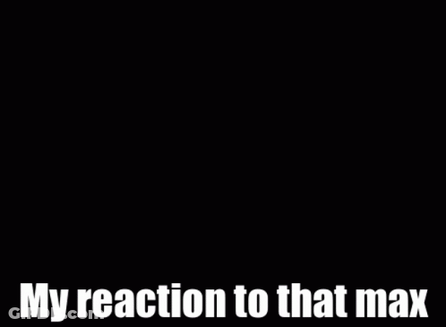 A Man In A Suit And Tie Is Smiling And Says My Reaction To That Max GIF