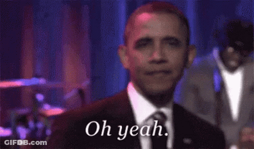 A Man In A Suit And Tie Is Smiling And Says Oh Yeah GIF