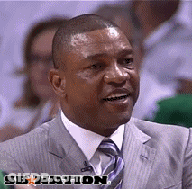 A Man In A Suit And Tie Is Smiling In Front Of A Banner That Says Sbnation GIF