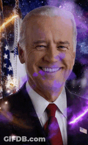 A Man In A Suit And Tie Is Smiling In Front Of A Purple Background GIF