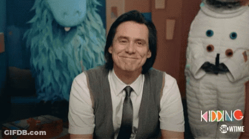 A Man In A Suit And Tie Is Smiling In Front Of A Showtime Logo GIF