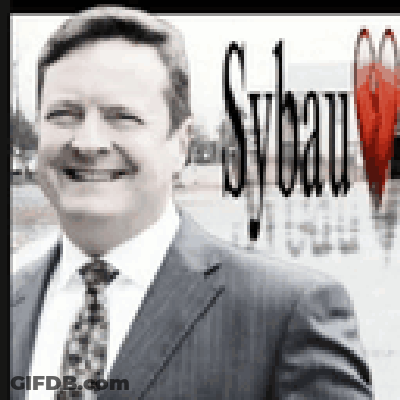 A Man In A Suit And Tie Is Smiling In Front Of A Sybau Logo GIF
