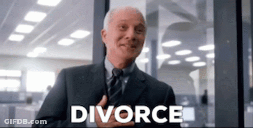 A Man In A Suit And Tie Is Smiling In Front Of A Window With The Word Divorce Written On It . GIF